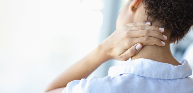 Frau reibt sich schmerzende Nacken